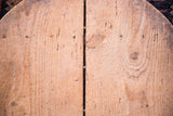 Patina on vintage wooden board, showcasing natural grain, hand-hewn marks, and central seam.
