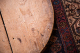 Vintage wooden pizza board with natural wood grain and rustic hand-hewn surface.
