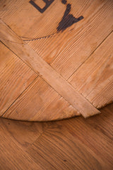 Curved edge detail of vintage wooden board with natural grain and visible aged patina.