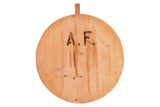 Rustic vintage wooden pizza serving board with dark 'A.F.' initials, natural wood grain, and patina.