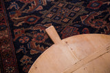 Vintage wooden pizza serving board handle with rustic wood grain and natural patina.