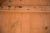 Rustic wooden board with hand-hewn nails and rich, aged patina.