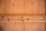 Vintage wood pizza board with hand hewn nails and aged patina.
