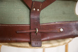 Brown leather strap, stamped '64', and green canvas on vintage Swiss Army bag.