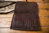 Vintage dark brown leather messenger bag, front flap with metal buckle and vertical stitched details.