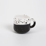 Handmade Modern Coffee Mug with speckled black and white two-tone design.