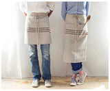 Natural linen long waist apron with dark grey stripes and large pocket.