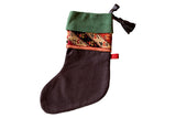 Heirloom charcoal stocking with a green suede cuff and a colorful antique rug fragment band.