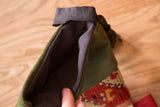 Interior view of the luxe heirloom stocking's textured charcoal lining and suede exterior.