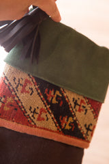 Detail of the rich green suede cuff and dark leather tassel on a luxe heirloom stocking.