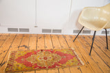 Antique Distressed Yastik rug, saffron yellow and brick red scalloped medallion, with tattered edges.