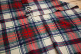 Soft wool texture vintage plaid blanket in red, green, navy, and cream with fringe.