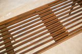 Detail of the mid century modern expandable slat bench's interlocking wood with vintage wear.