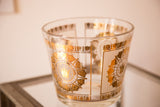 Mid Century glass ice bucket close-up of gold crown and intricate medallion pattern.