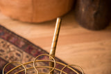 Textured brass pole detail on the vintage Hollywood Regency bar cart.
