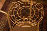 Top-down view of the vintage Hollywood Regency brass bar cart's cup holders.
