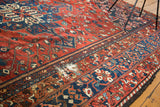 Distressed vintage Bakhtiari carpet section, red, indigo, and ivory rectilinear patterns.