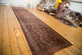 Distressed vintage Bijar runner featuring Herati bouquet pattern and faded cherry red details.
