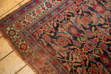 Distressed Bijar runner end, displaying classic Herati pattern in cherry red, indigo, sky blue.