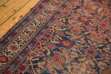 Distressed vintage Bijar rug's Herati pattern, showcasing cherry red, indigo, and ivory tones.