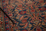 Textured Herati pattern in indigo, cherry red, and ivory on a distressed vintage Bijar rug.