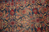 Distressed texture of the Persian Bijar rug featuring Herati motifs in red, indigo, and saffron.