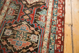 Intricate geometric border and tribal patterns in madder red, teal, and blush rose.
