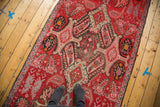 Distressed Karabagh runner with oversized medallions, paisley botehs, and faded blood orange.