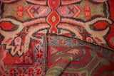 Distressed blood orange geometric patterns on an antique Karabagh rug, revealing its striped back.