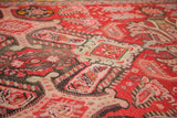 Distressed antique Karabagh rug close-up showing worn paisley botehs and floral motifs.