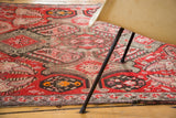 Antique distressed Karabagh runner texture with brilliant red field and multi-hued botanical motifs.