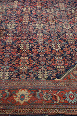 Textured vintage Mahal rug, indigo guli-hinnai pattern with red, ivory, and black cherry border.
