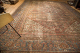 Faded blue border with turtle motif and peach Herati pattern on antique Mahal rug.