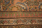 Faded peach, blue Herati design and geometric turtle motif border on a distressed Mahal carpet.
