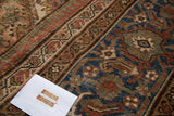 Distressed Mahal Carpet border with faded turtle motif and muted blue Herati field pattern.