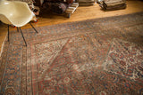 Distressed Herati pattern on antique Mahal carpet with faded peach, blue, and ivory.