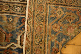 Distressed pile texture with faded blue, peach, and ivory on an antique Mahal border.
