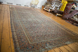 Antique distressed Persian Doroksh rug with intricate allover motifs and worn pile texture.
