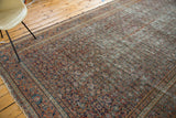 Fine, intricate traditional patterns in rust, navy, and ivory on a distressed antique Doroksh rug.
