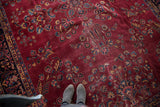Traditional distressed vintage Turkish carpet with plum field and navy floral design.