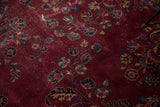 Textured plum field of vintage Turkish carpet with worn traditional floral bouquet motifs.