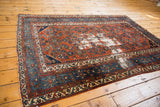 Distressed madder root red field with visible Herati pattern and sky blue samovar border.