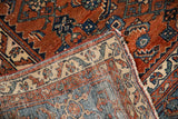 Distressed vintage Malayer rug with sky blue samovar border and madder red field texture.