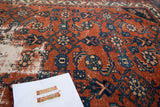 Vintage Distressed Malayer rug showing exposed foundation and Herati design on red field.
