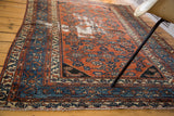 Distressed Malayer rug featuring madder red Herati field and blue samovar border.