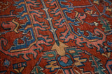 Distressed Vintage Heriz carpet texture, brick red field with blue, blush rose sickle motifs.