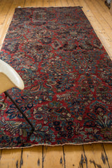 Secured end of Vintage Sarouk runner, featuring exquisite cherry red floral bouquets.