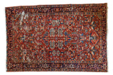 Vintage Heriz carpet with cherry red field, allover geometric design, and rich patina, 7'1