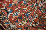 Hand-knotted Vintage Heriz rug, geometric pattern, rich cherry red, jewel blue, and textural pile.