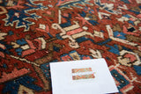Bold geometric patterns on Vintage Heriz carpet, showcasing cherry red, jewel blue, and warm textured tones.
